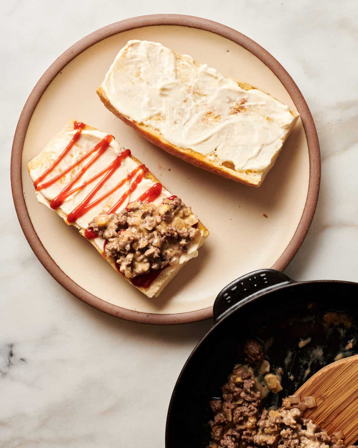 Chopped Cheese being built on a plate. 