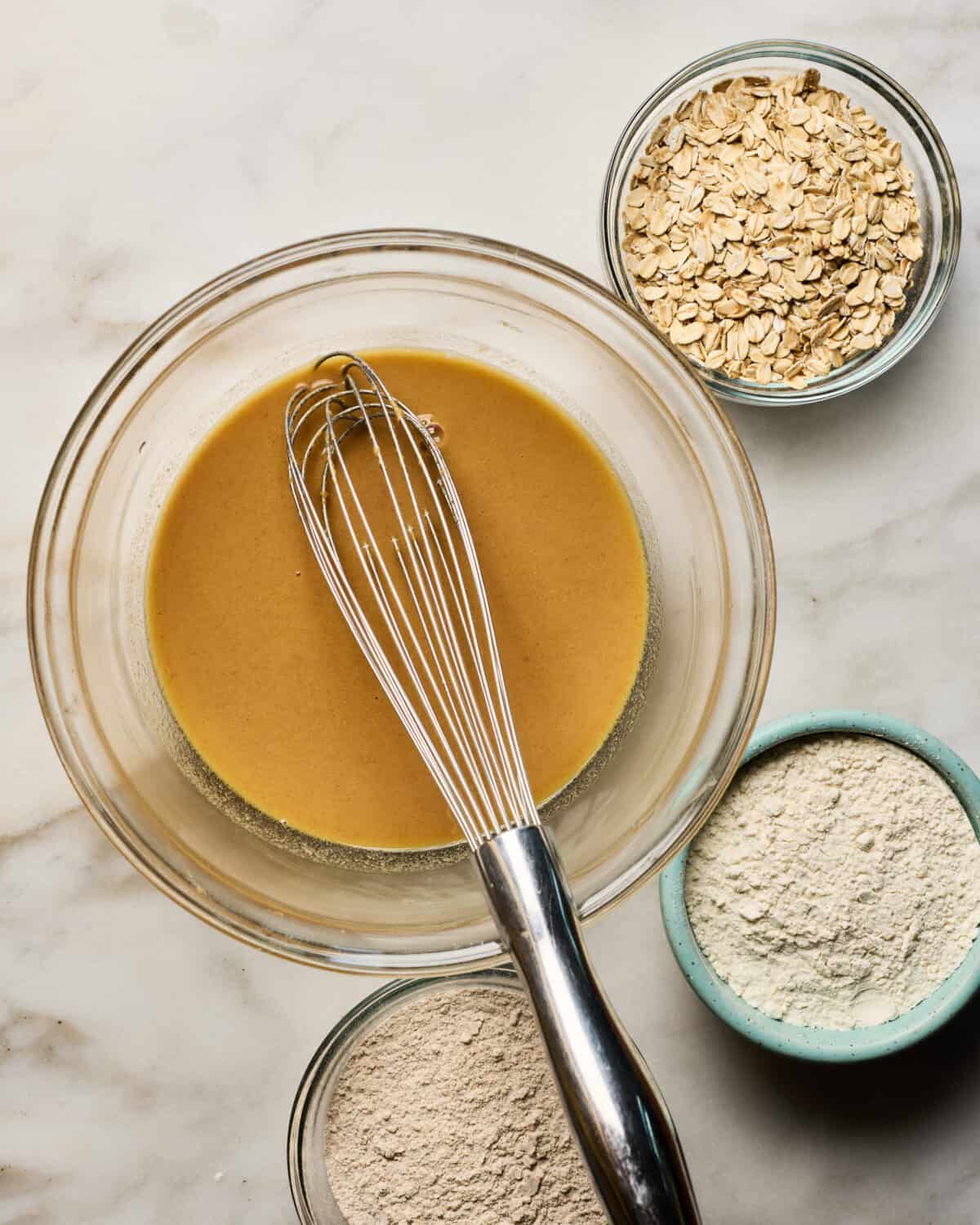 Ingredients being mixed together in large bowl. 