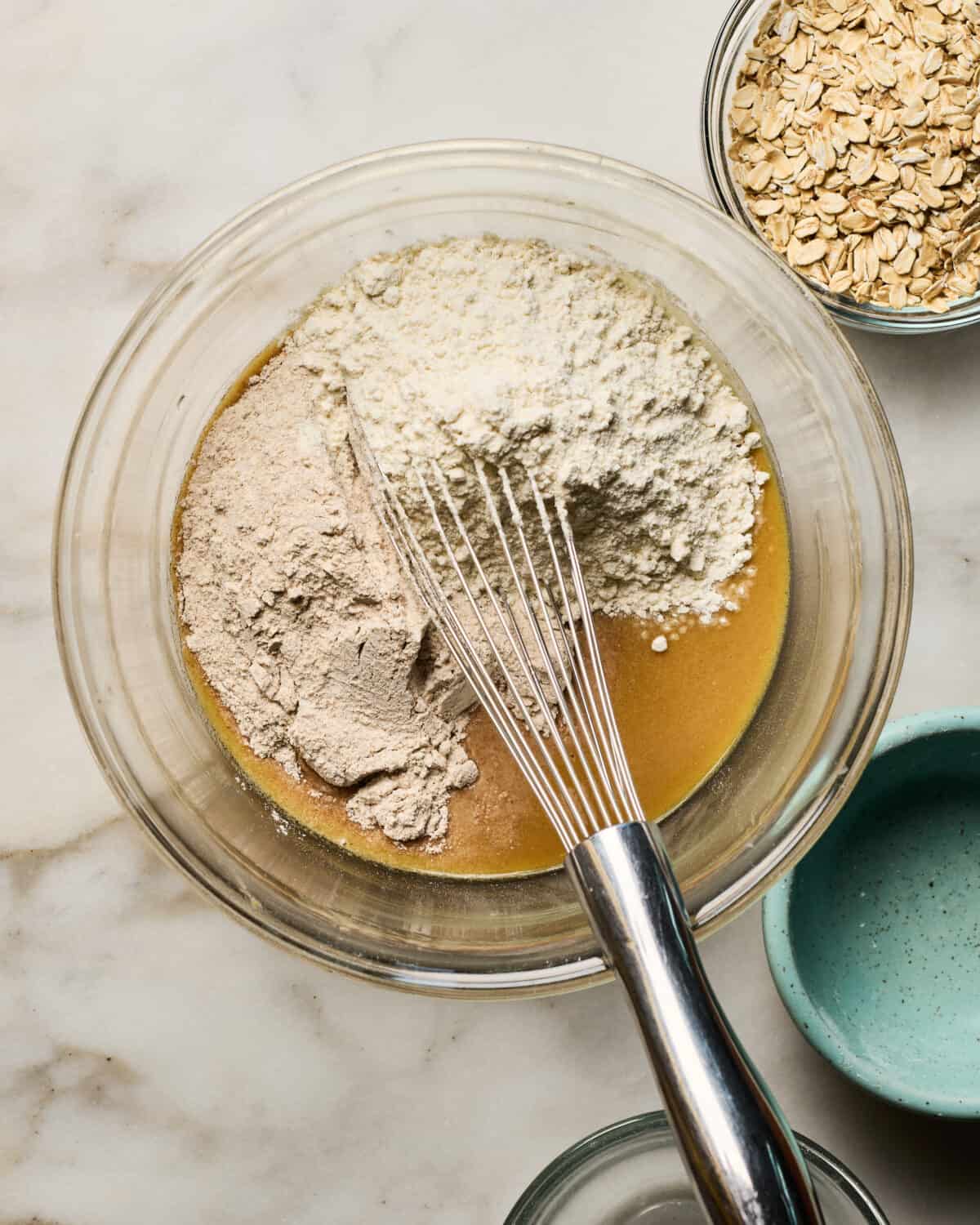 Ingredients being mixed together in large bowl. 