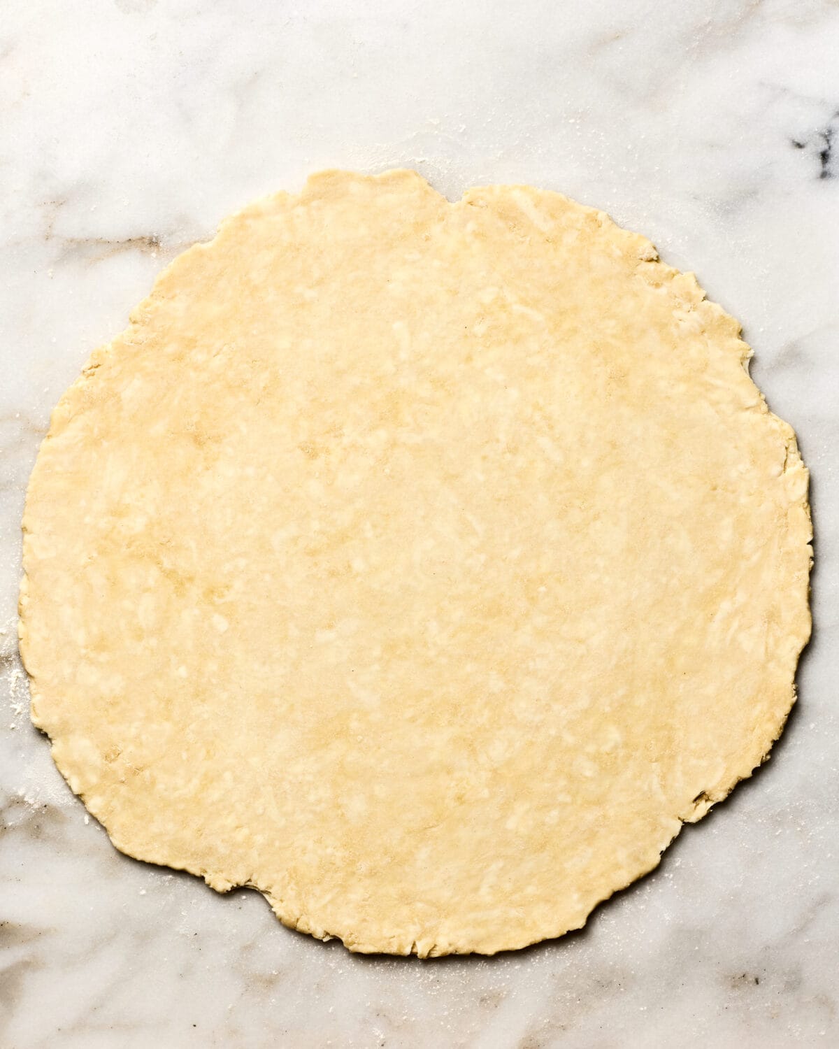 Rolled out pie crust on the counter. 
