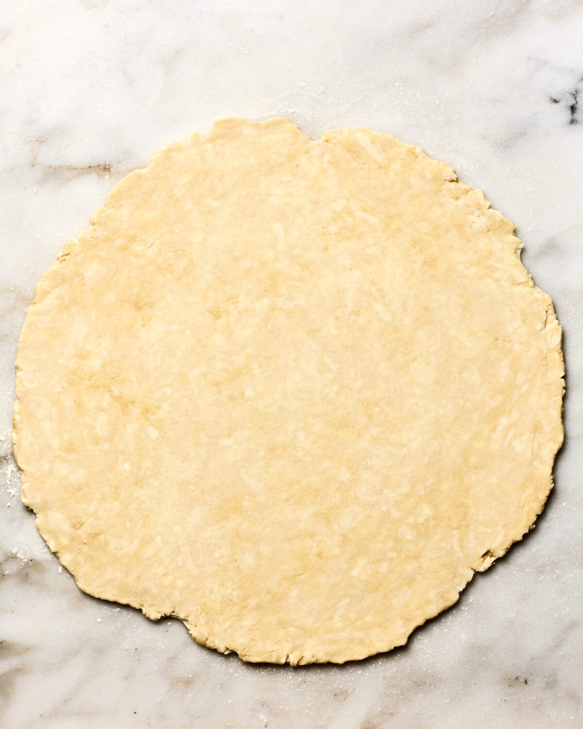 Rolled out pie crust on the counter. 