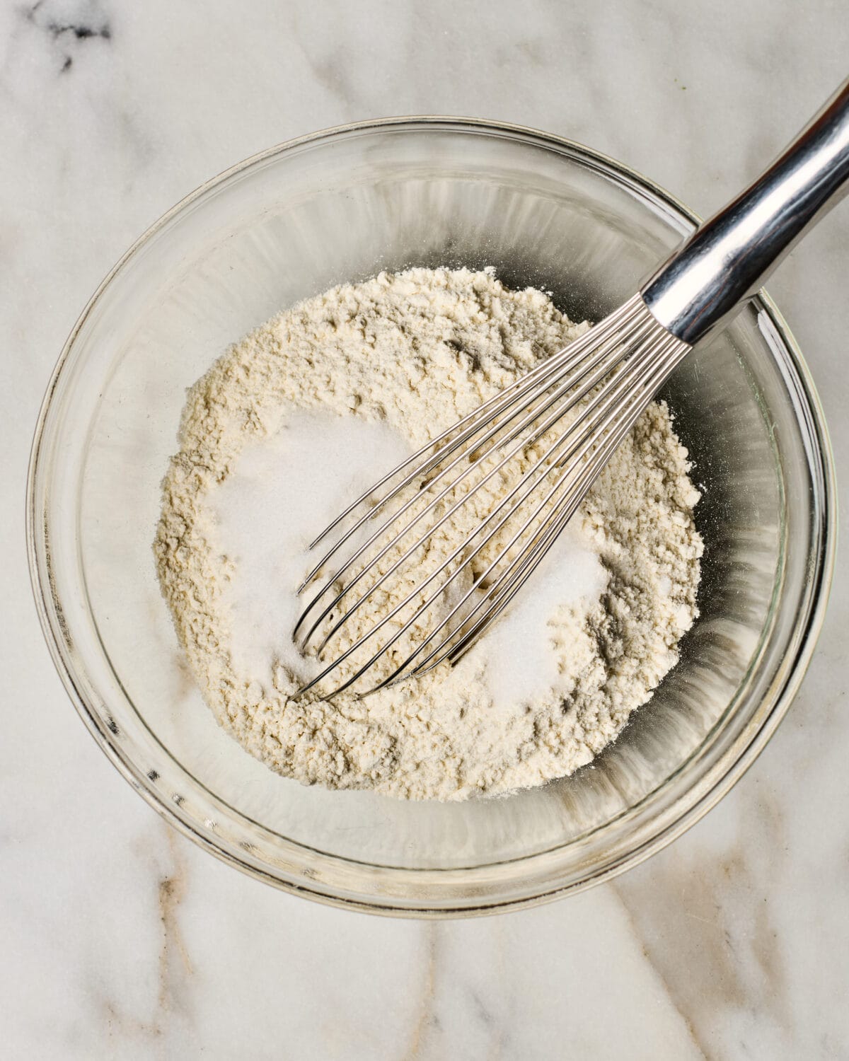 Dough being mixed together in a bowl. 