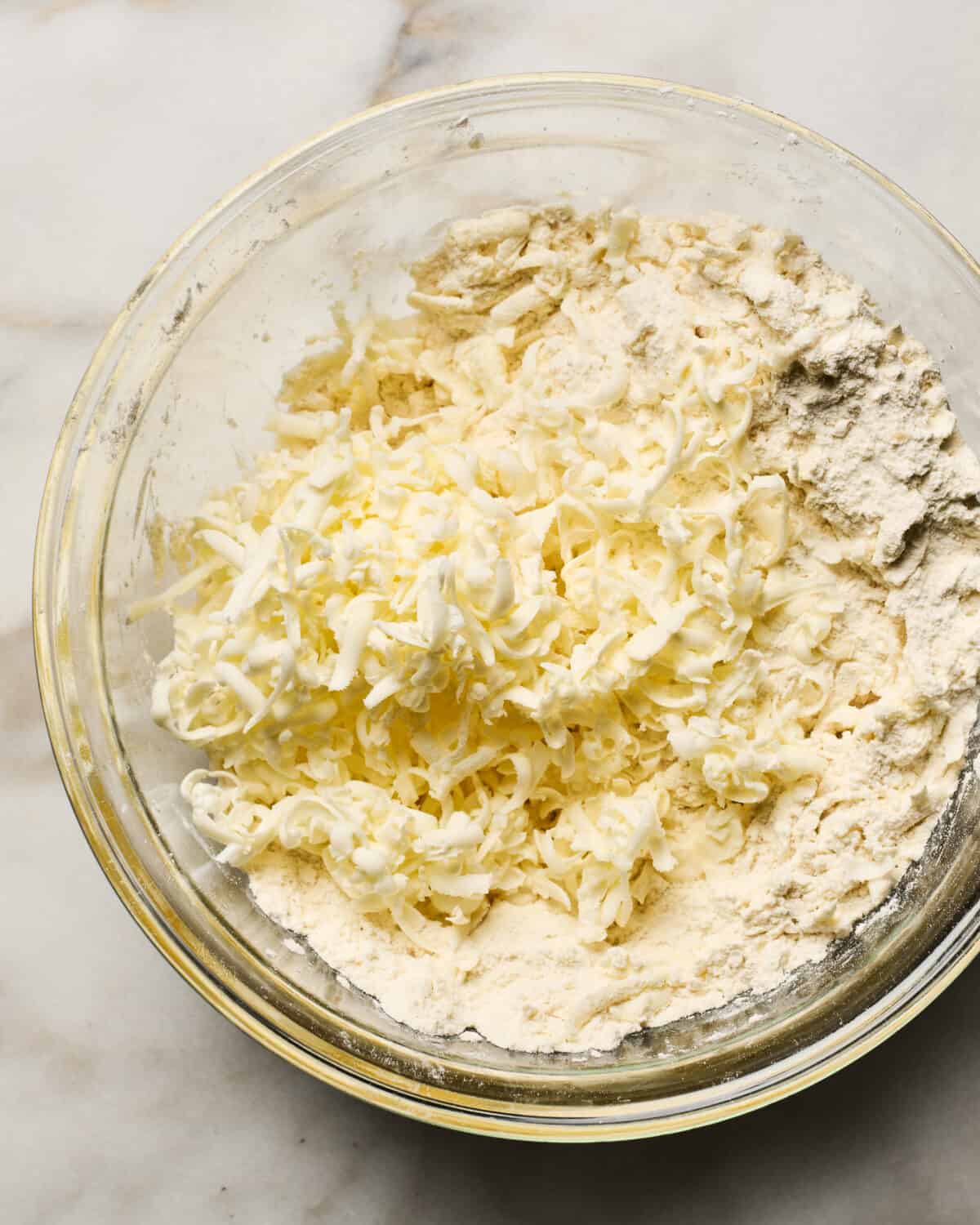 Dough being mixed together in a bowl. 