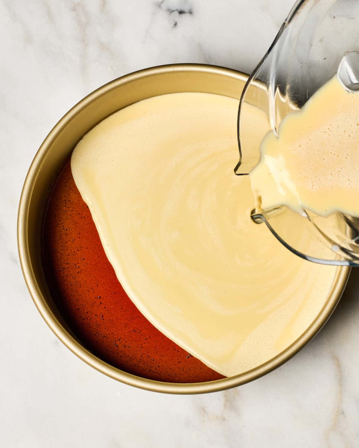 Custard being poured into the pan. 
