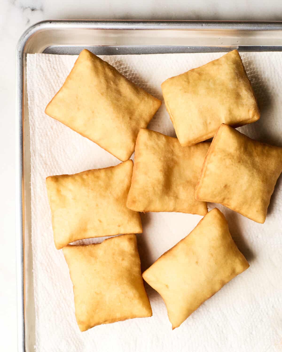 Sopapillas on paper towel. 