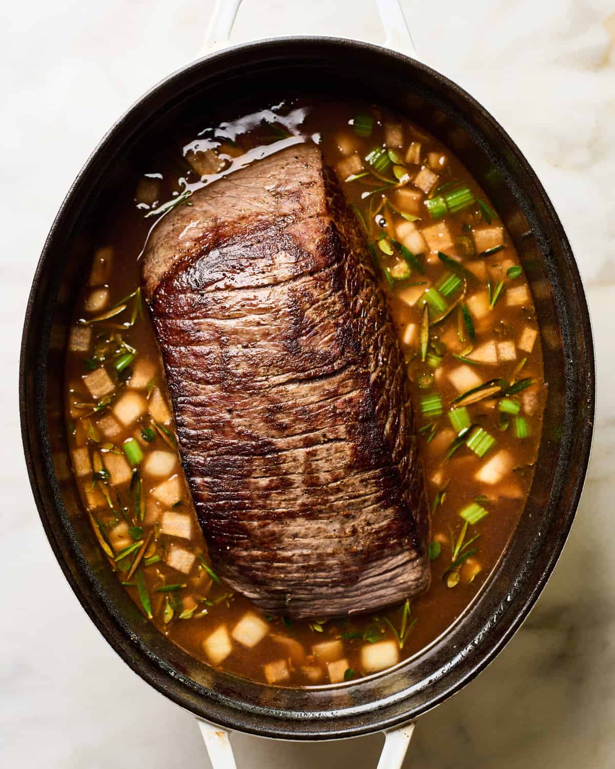 Pot roast about to be cooked in a Dutch oven. 