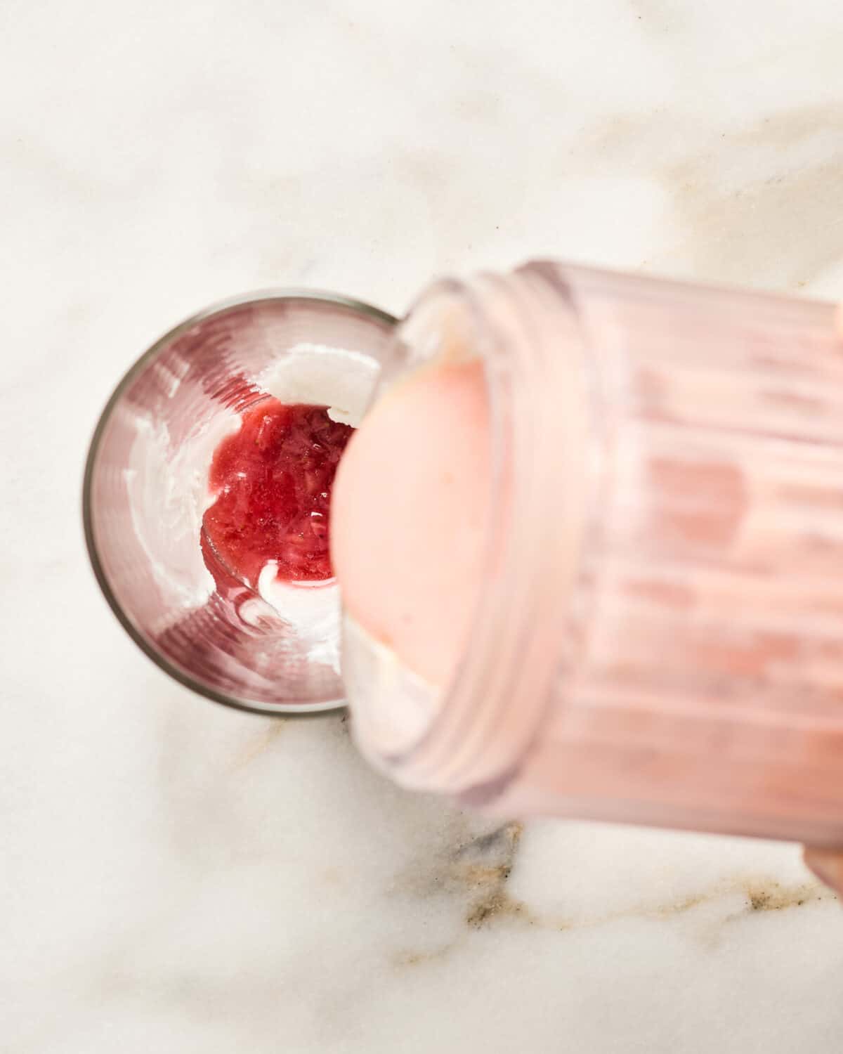 Pouring the smoothie into the glass. 