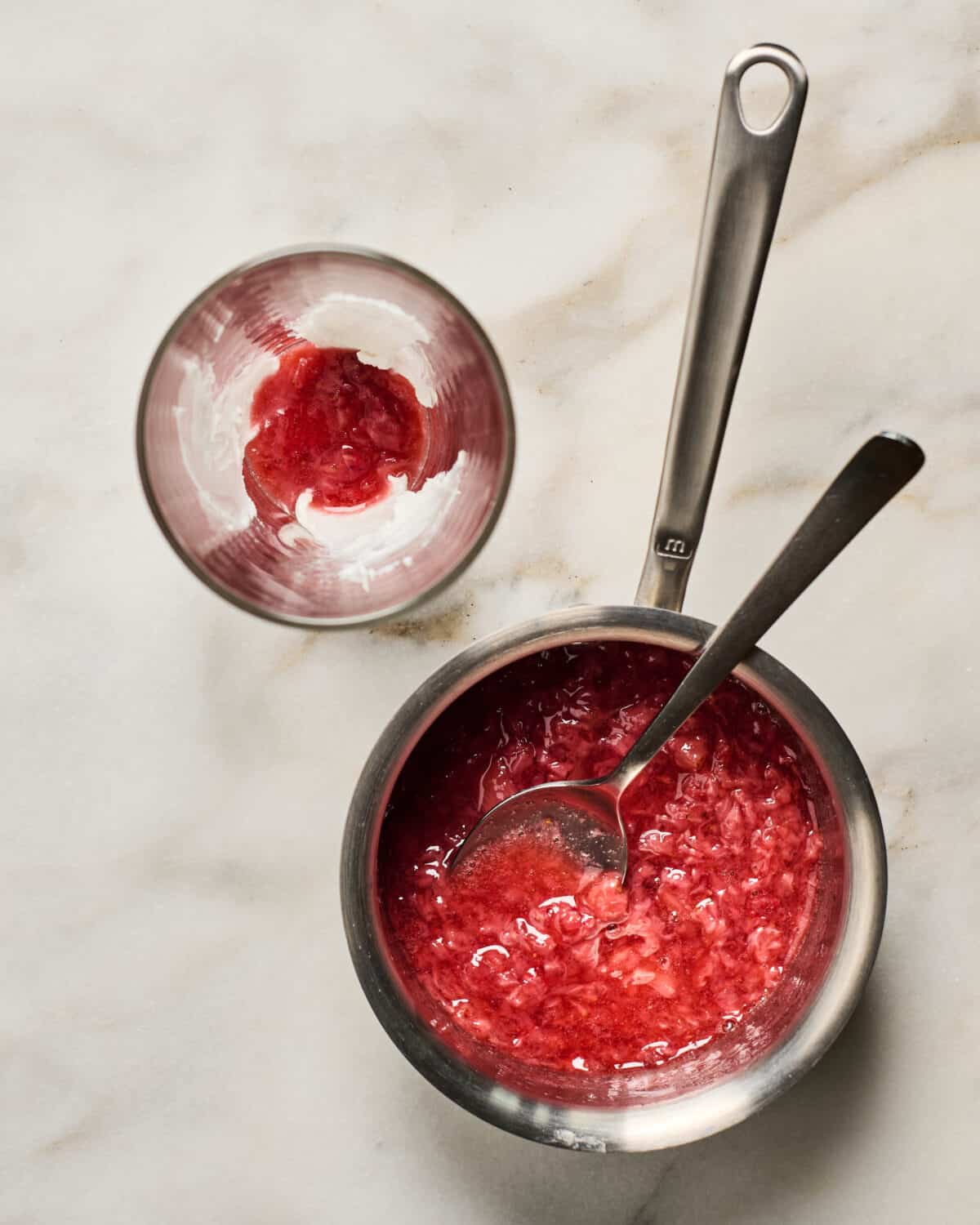 Cooking the strawberry glaze in pan. 