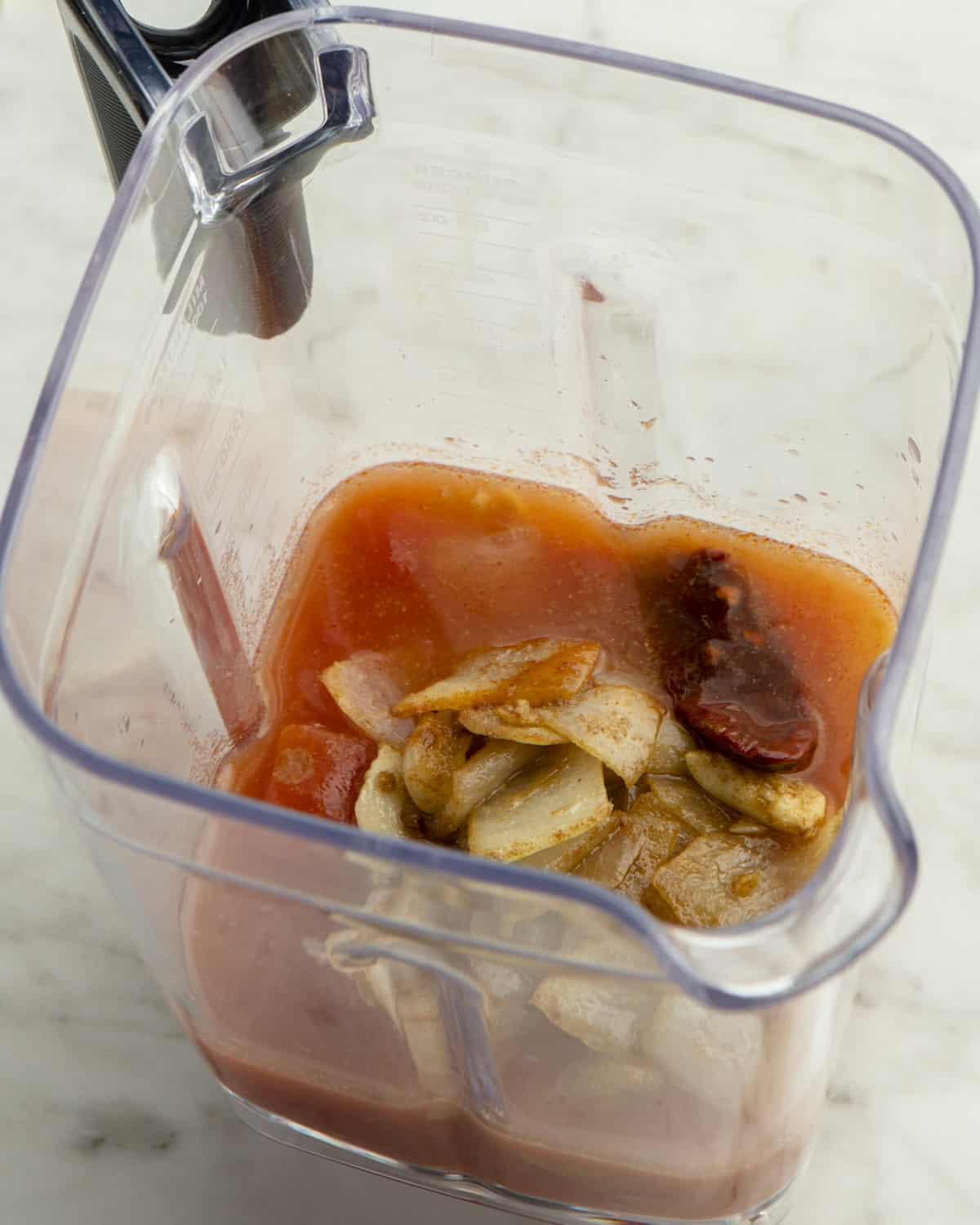 Cooked onions and garlic, chipotle in adobo, diced tomatoes, and broth in blender.