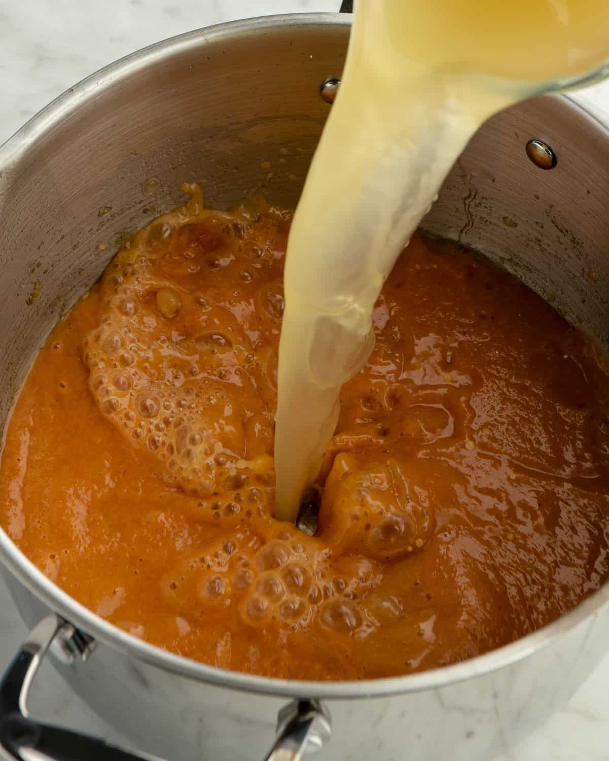Chicken tortilla soup broth in pot.