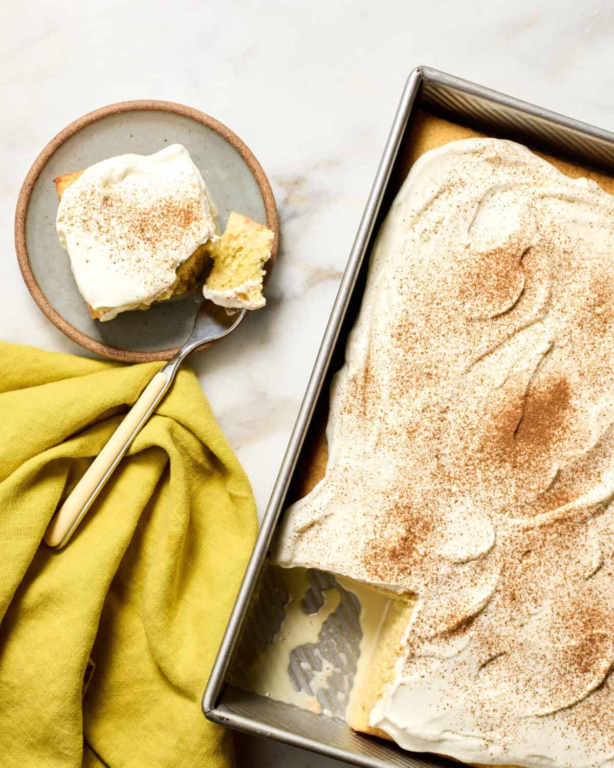 Tres Leches in pan with slice taken out. 