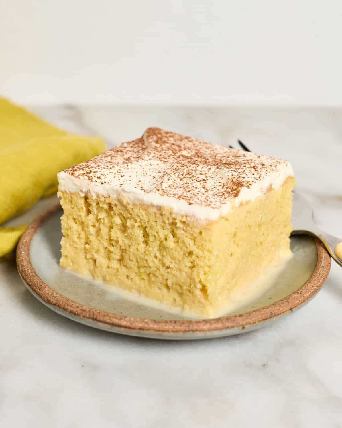 Slice of Tres Leches Cake on a plate.