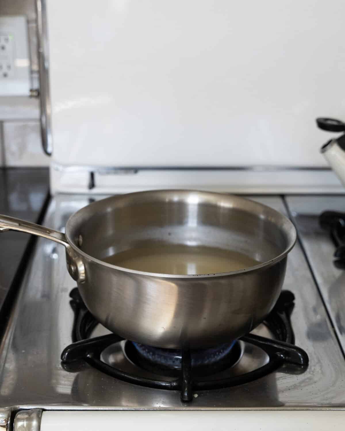 Pot of sugar and water cooking. 