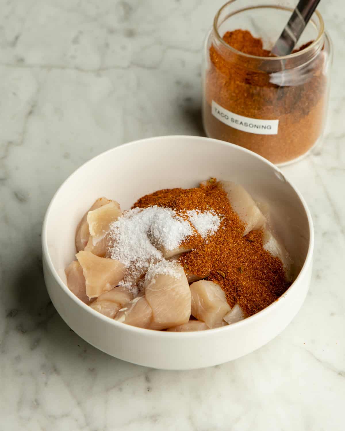 Taco Seasoning and salt on chicken. 
