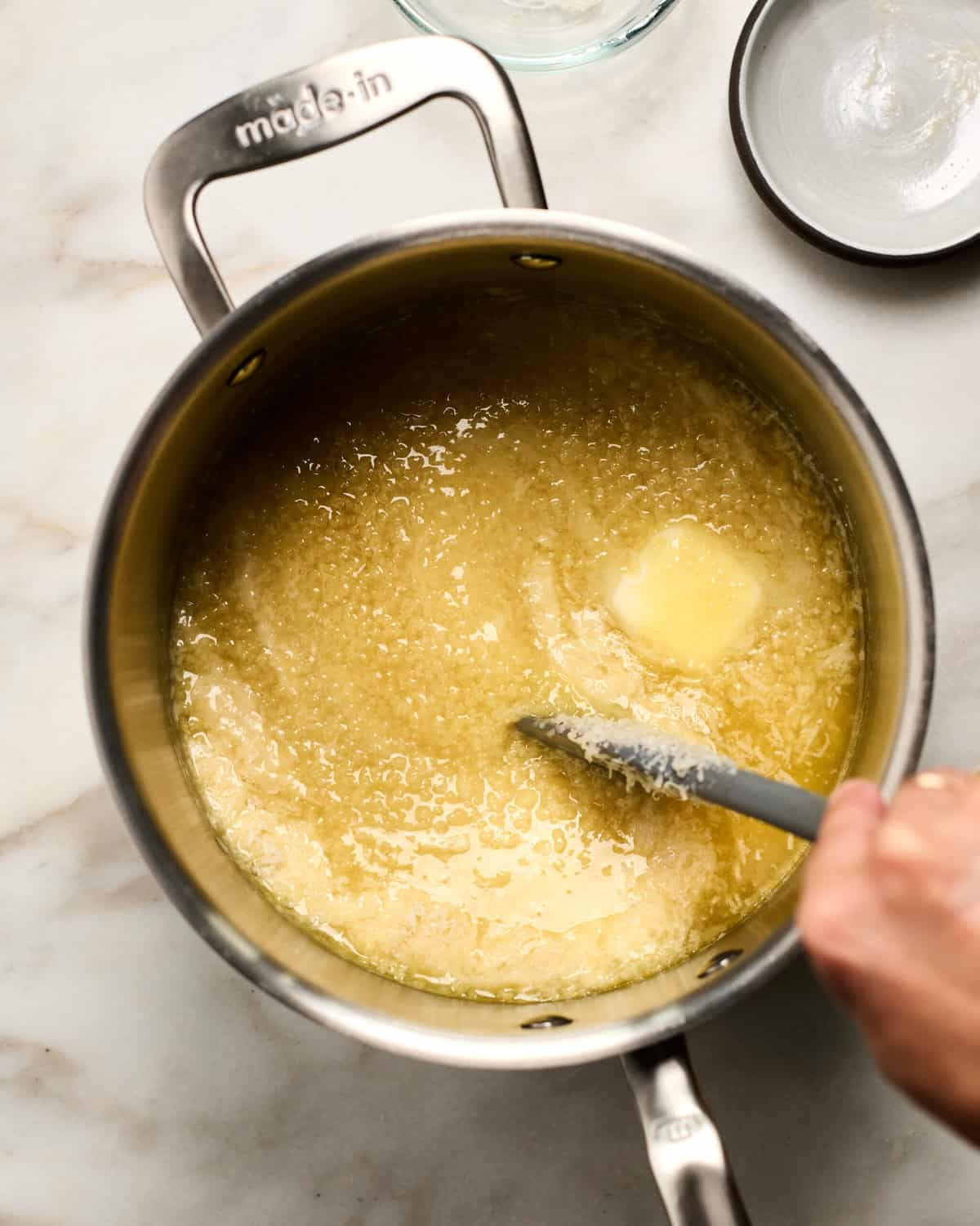Butter and parmesan being stirred in.