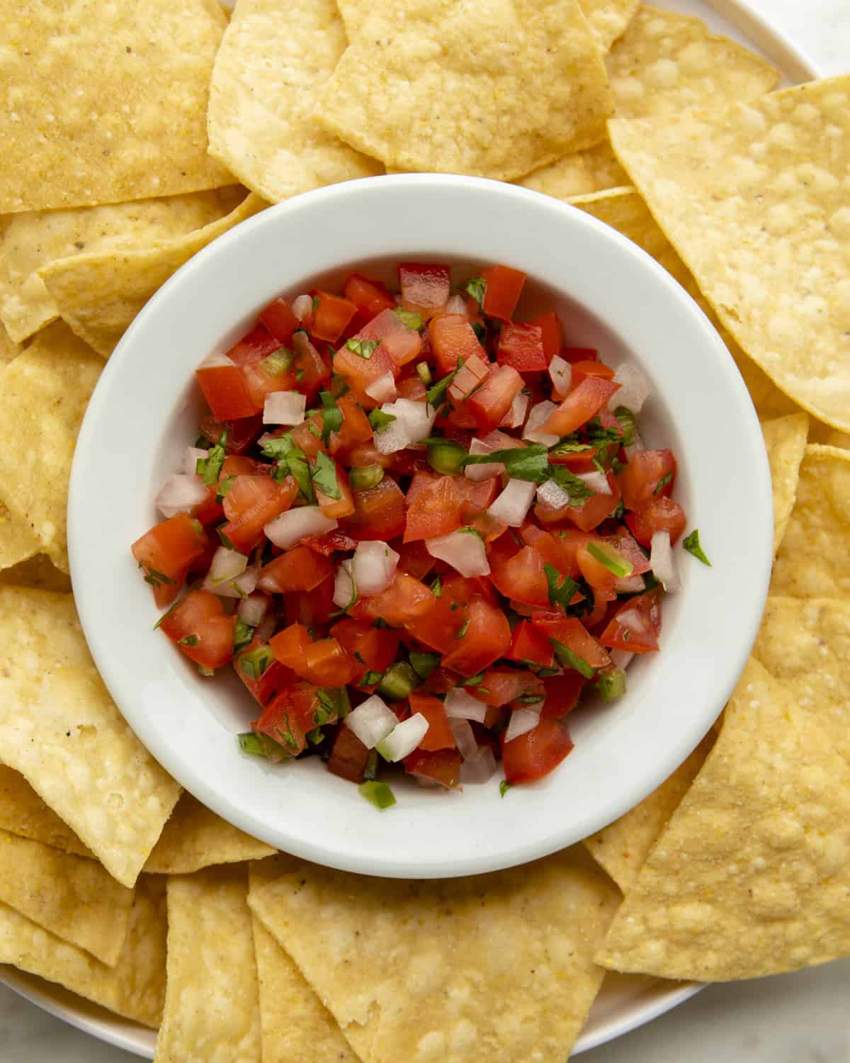 Authentic Pico de Gallo in a bowl with chips. 