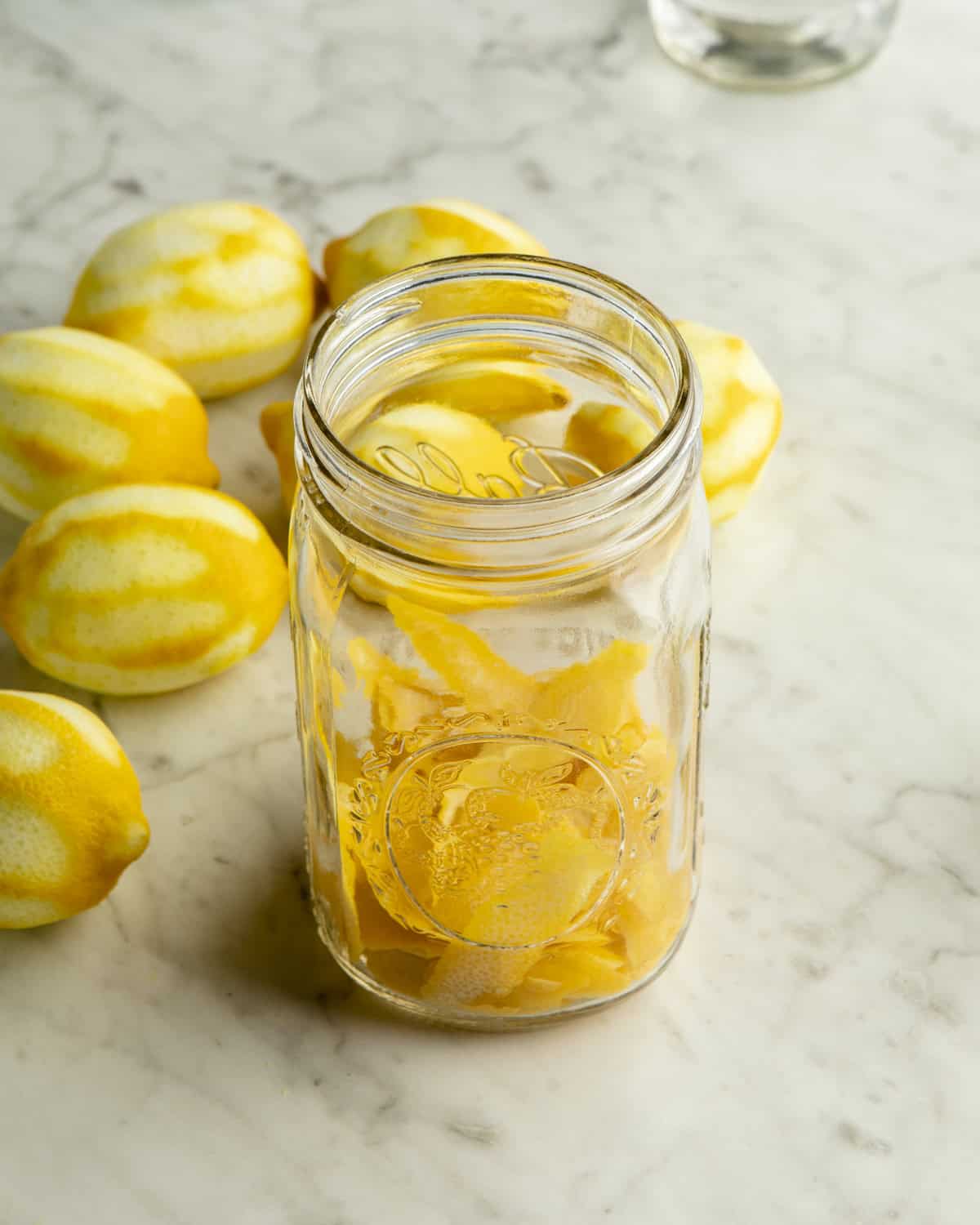 Lemon peels added to a jar. 