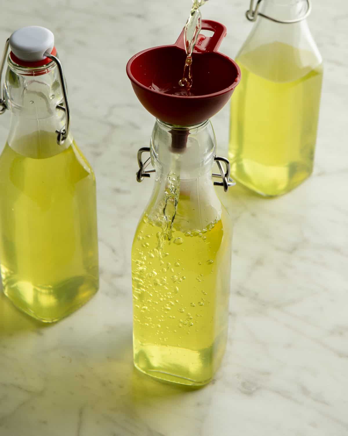 Homemade Limoncello added to bottles. 
