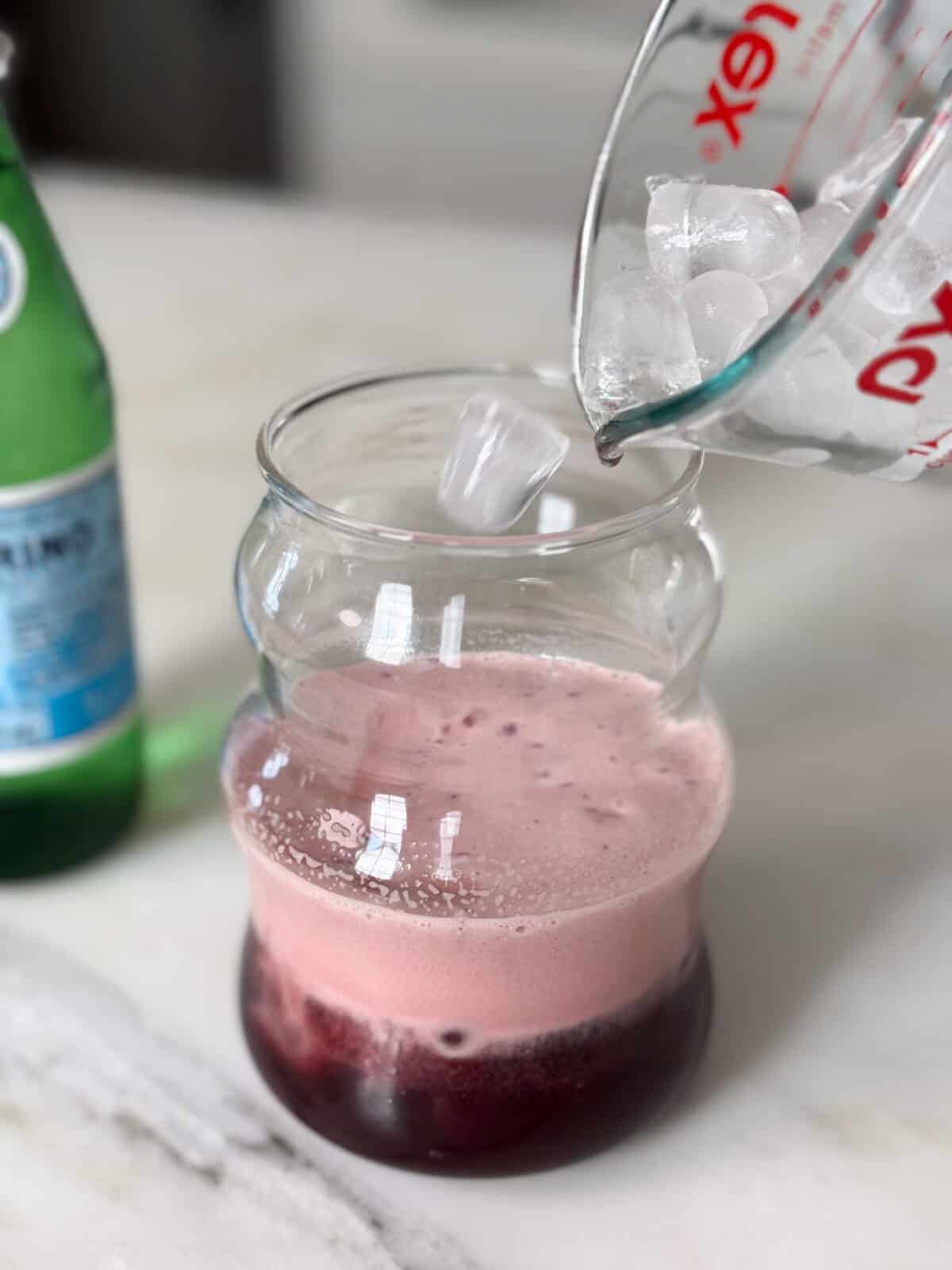 Ice being added to glass. 
