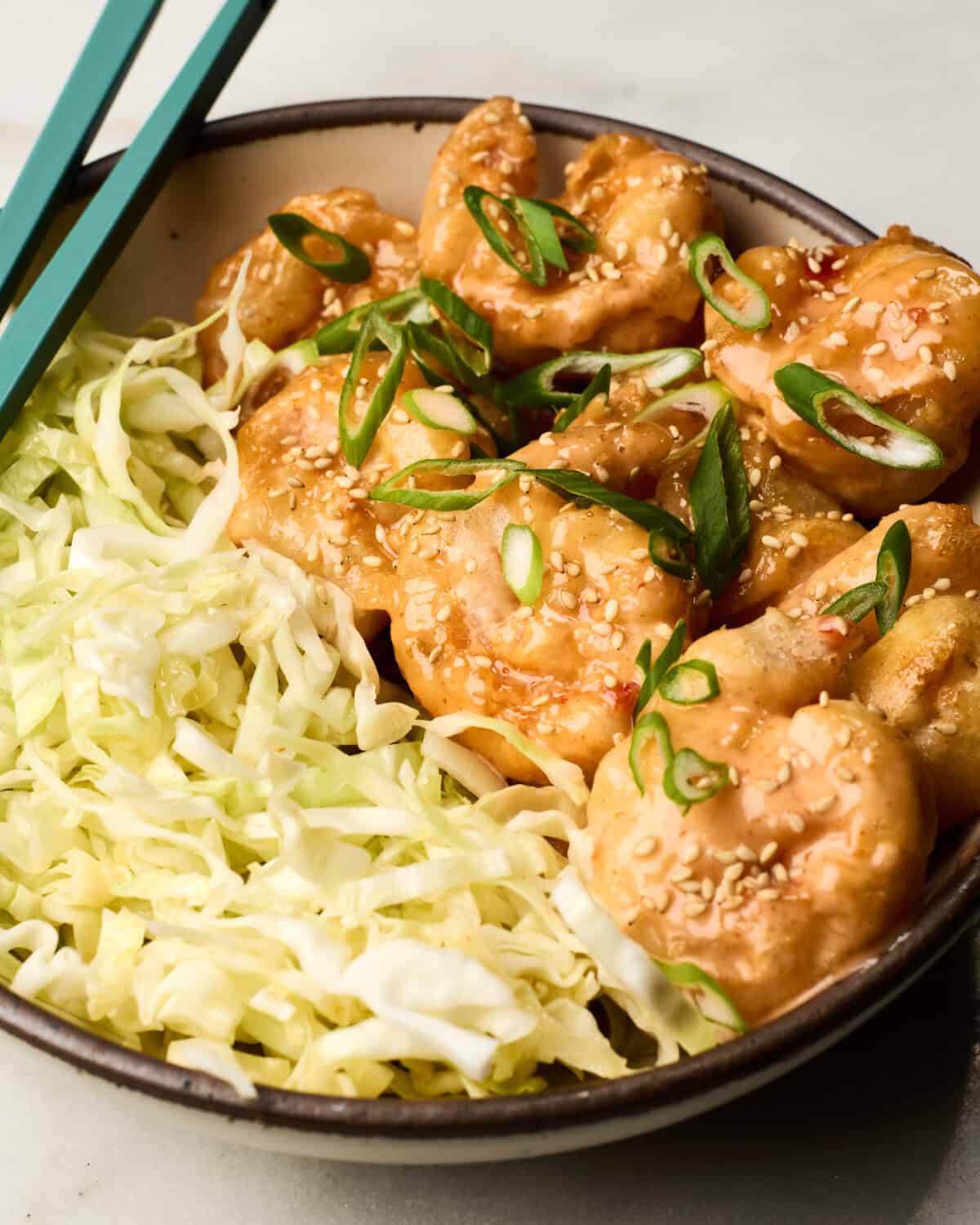 Bang Bang Shrimp in a bowl with cabbage.