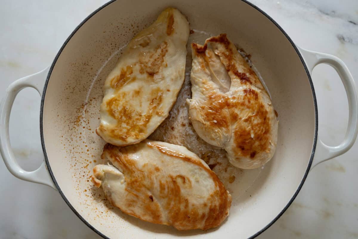 Chicken cooking in a pan. 