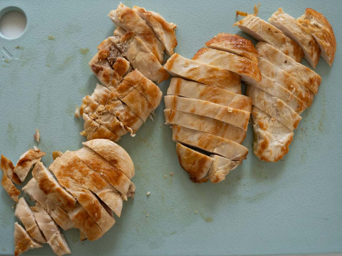 Chicken slices on cutting board.
