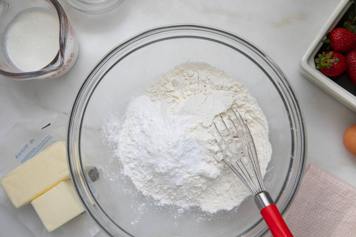 Dry ingredients being whisked together in a bowl. 