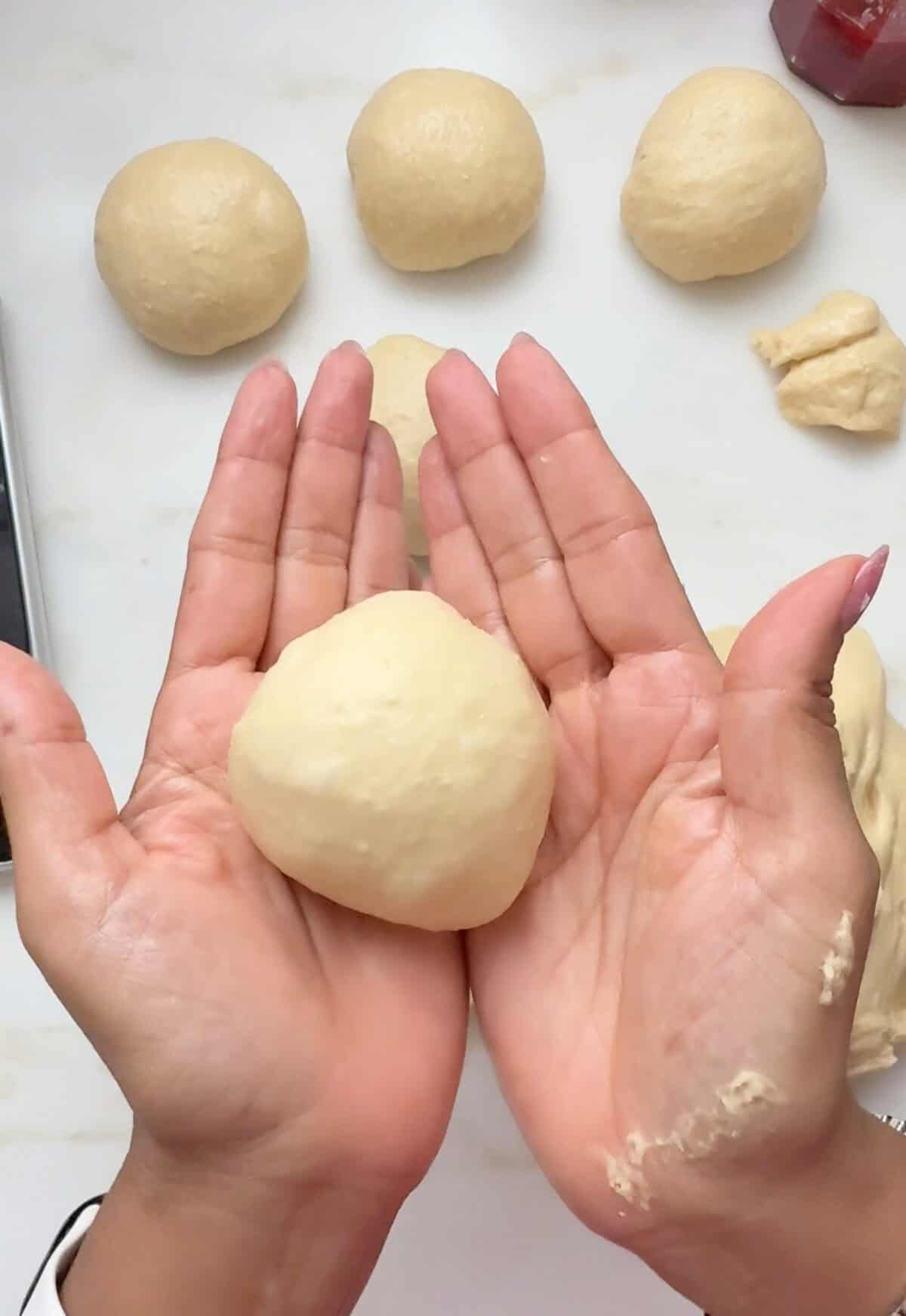 Hand holding dough.