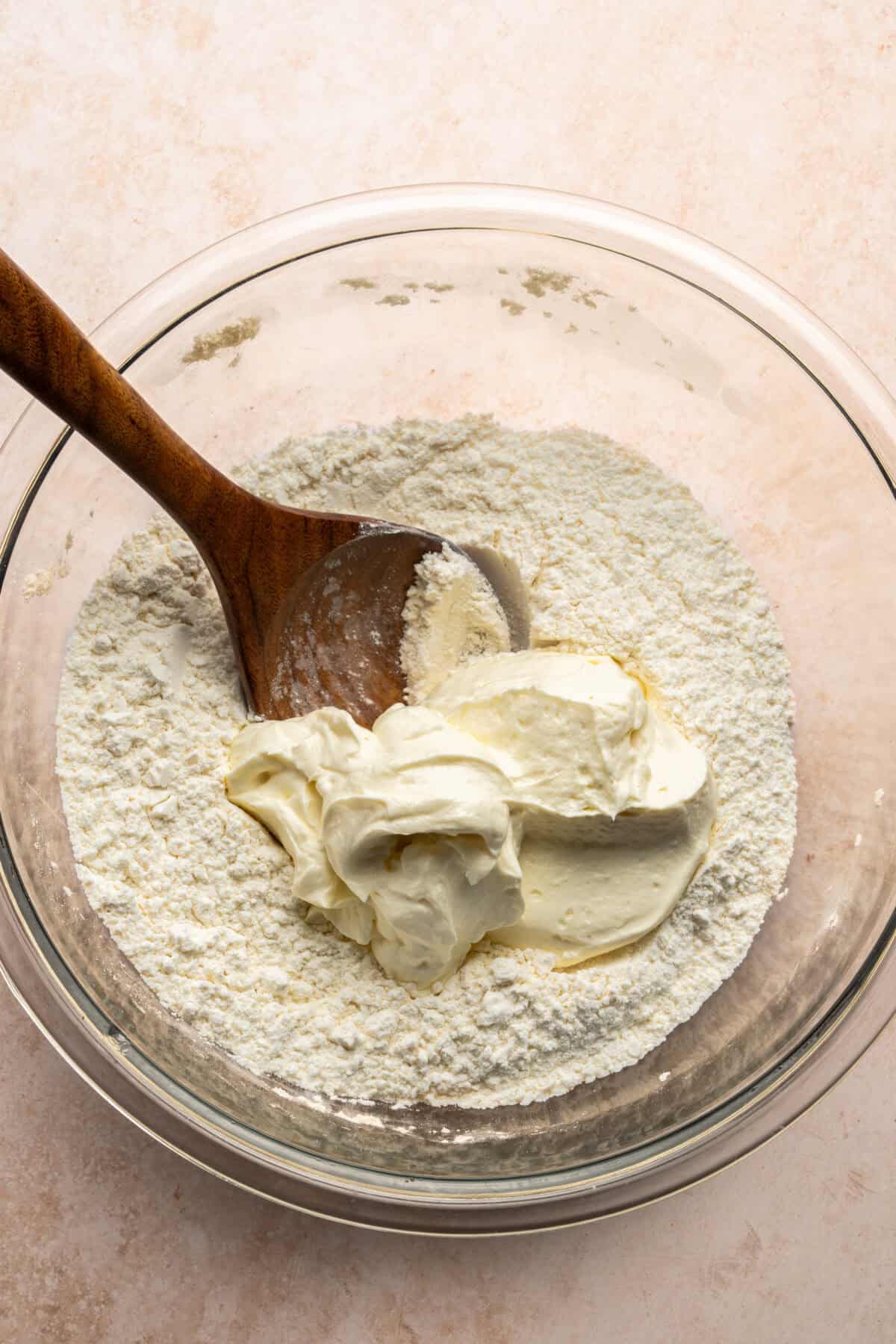 Yogurt being mixed into the dough.