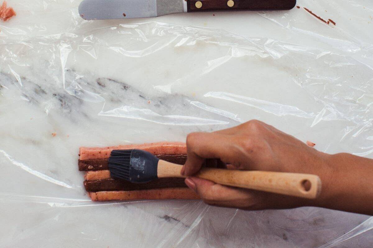 Strawberry Chocolate Checkered Cookies being assembled.