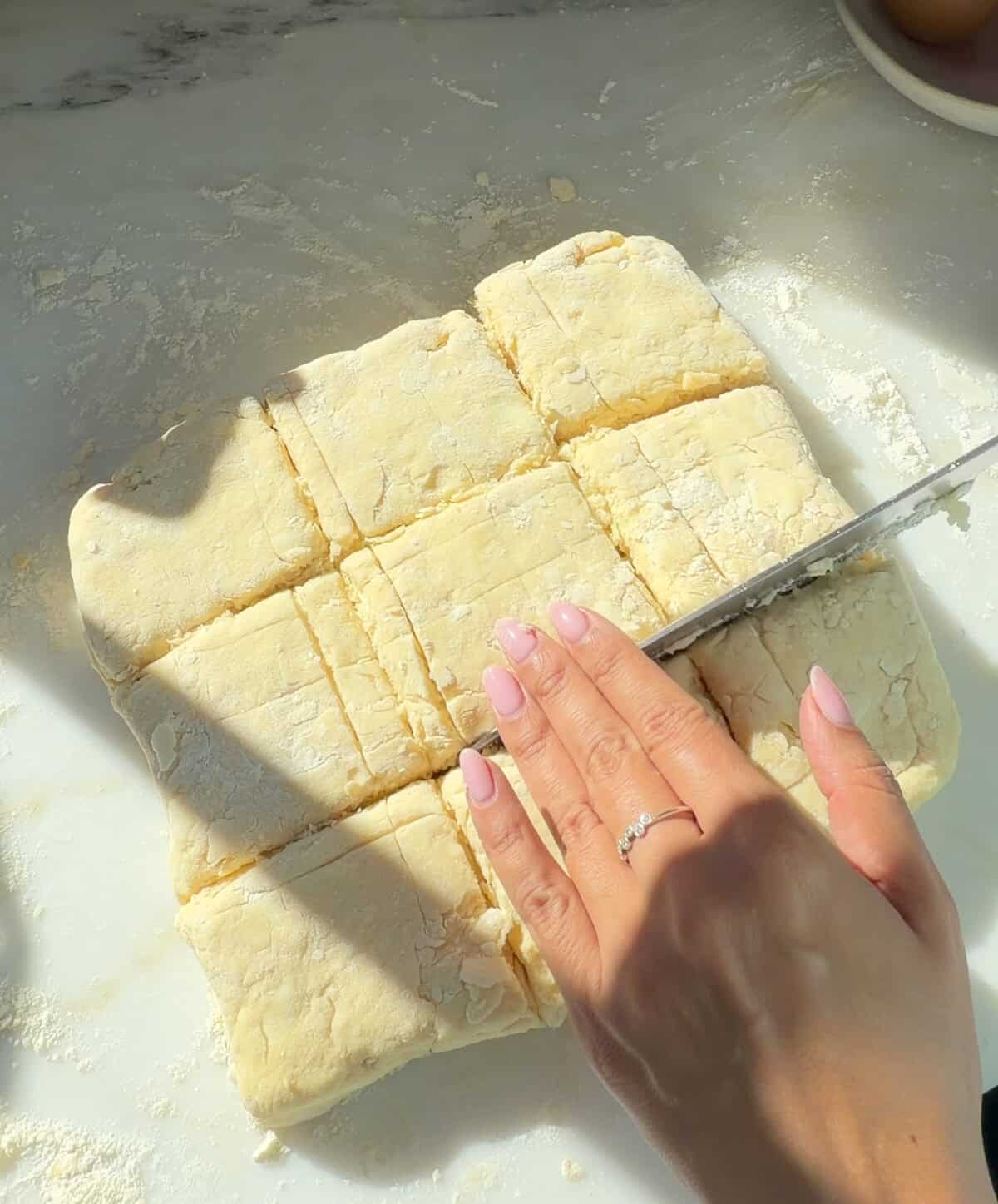 Biscuit dough being cut.