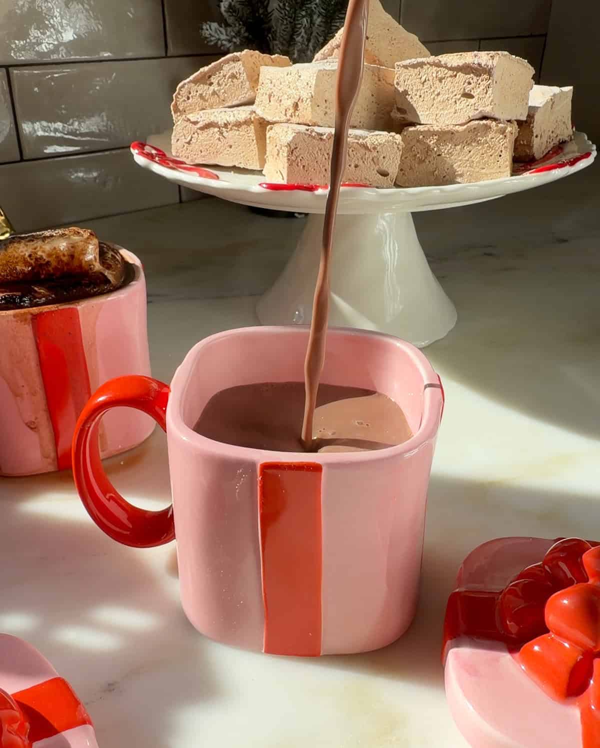 Homemade hot chocolate pouring into mug.