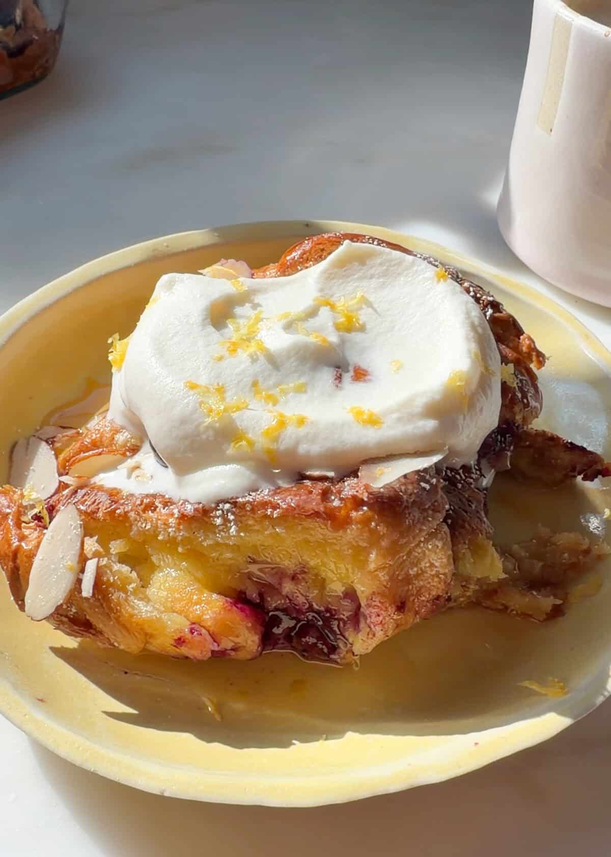 Lemon Blueberry Overnight French Toast with whipped cream and lemon zest.