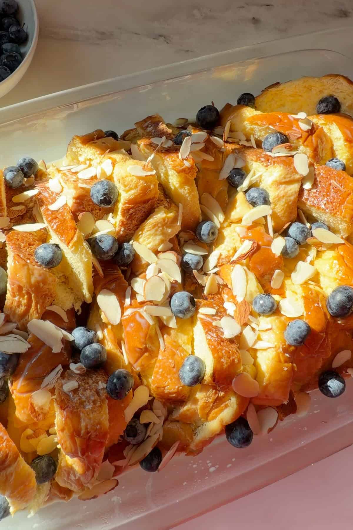 Lemon Blueberry Overnight French Toast topped with blueberries and slivered almonds.