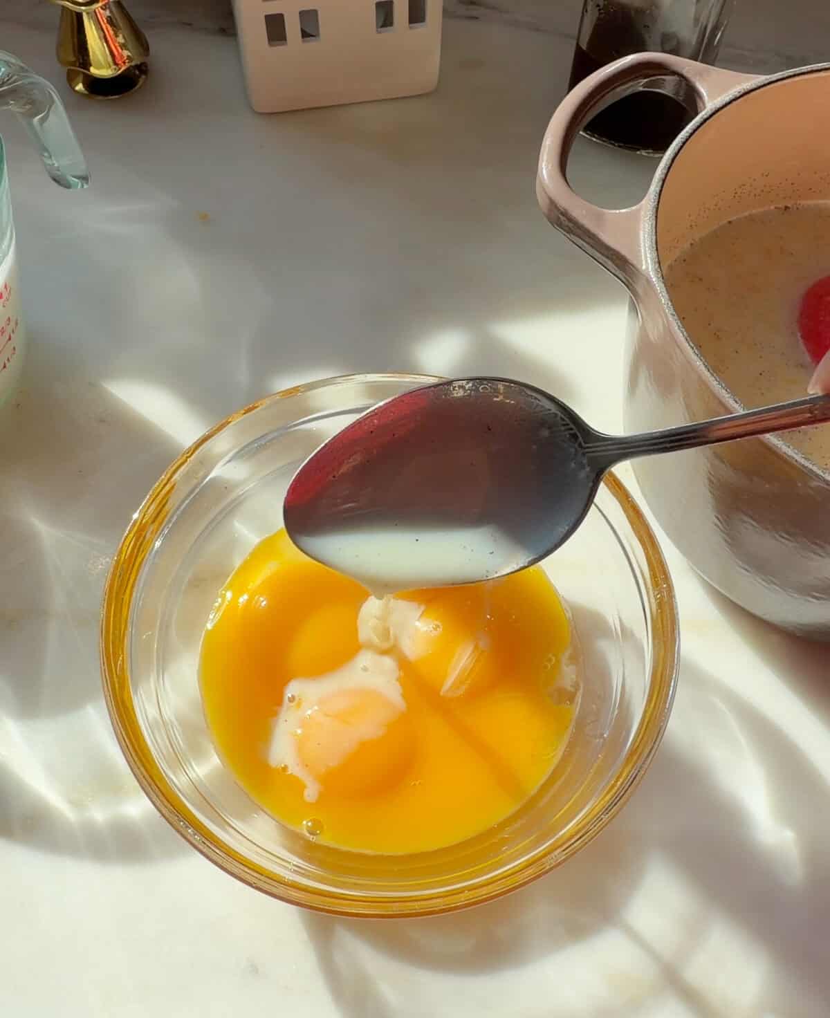 Egg yolks with warm milk mixture.