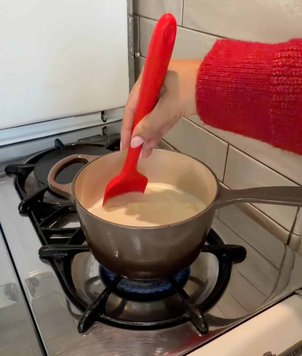 Milk and sugar mixture in pot.