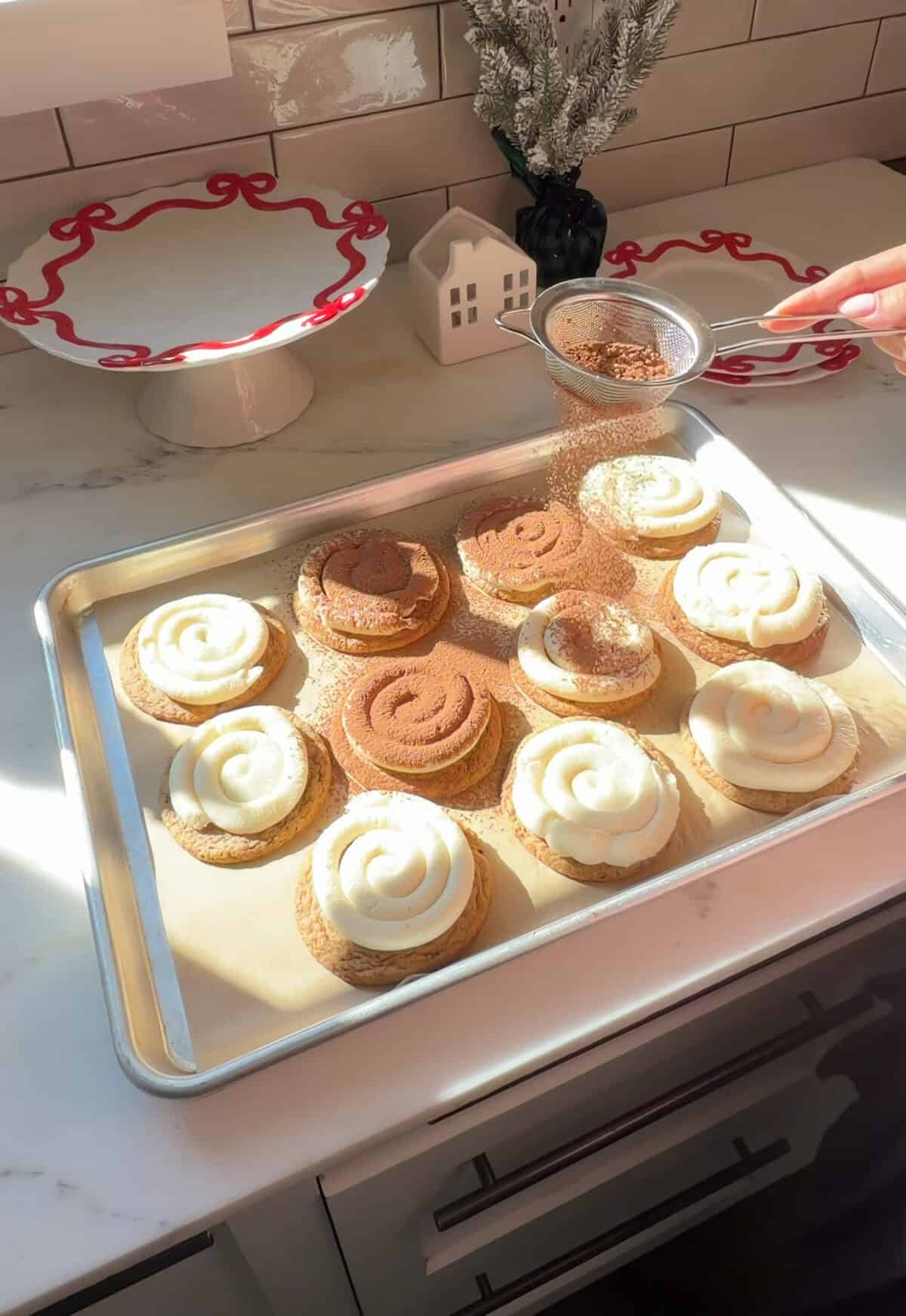 Tiramisu cookies being dusted with cocoa powder.