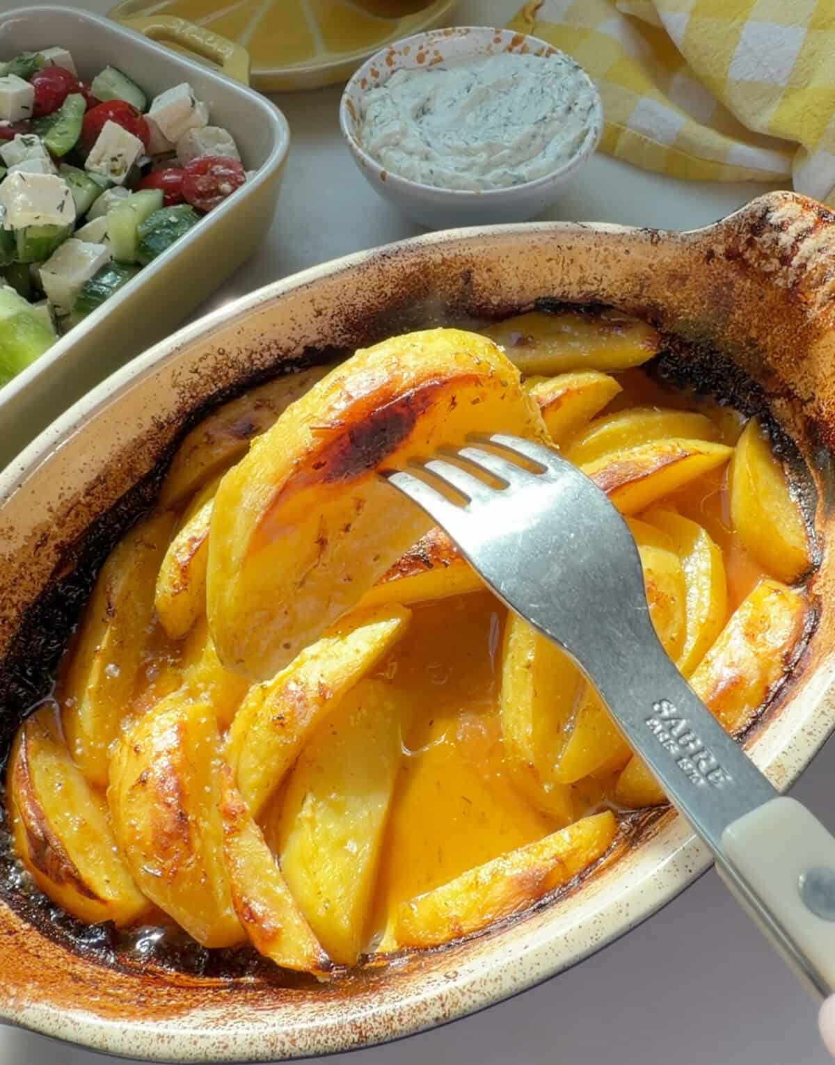 A fork with Greek Lemon Potatoes.