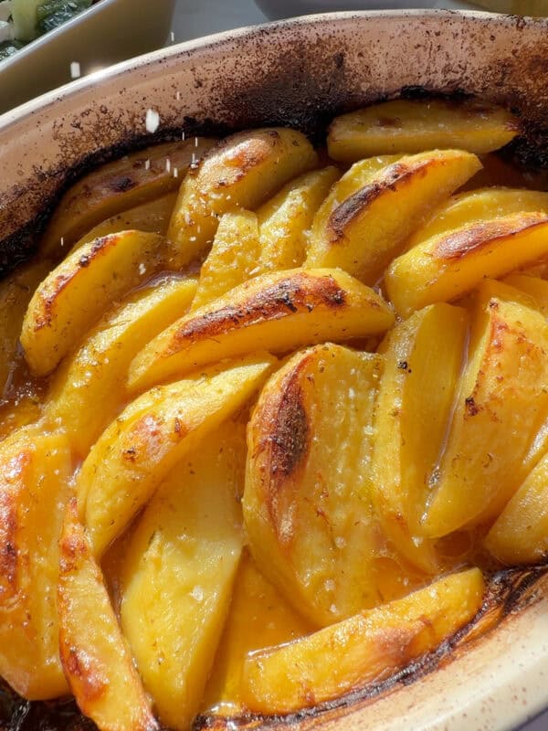 Flakey sea salt being garnished on Greek Lemon Potatoes.