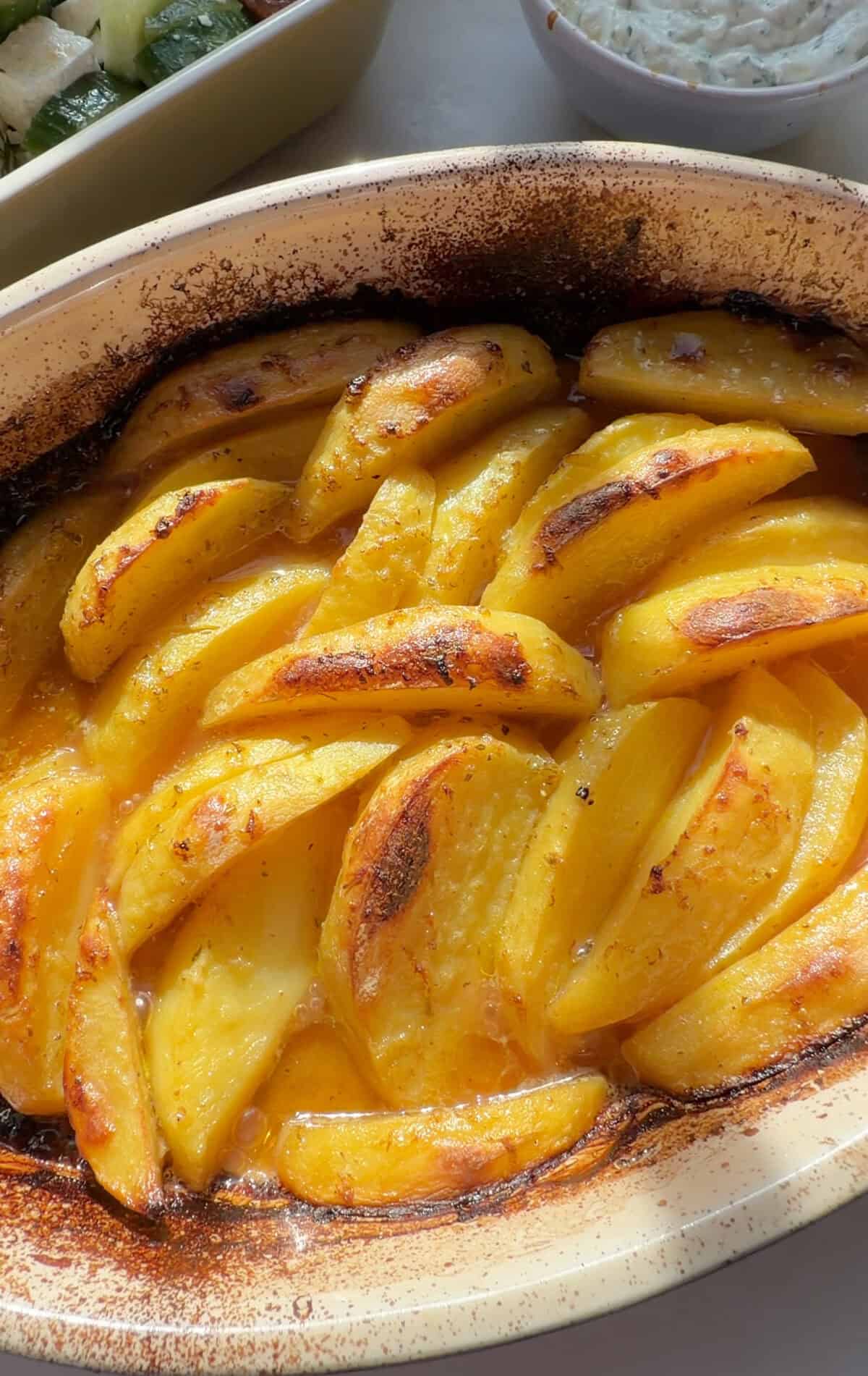 Greek Lemon Potatoes baked in baking dish.