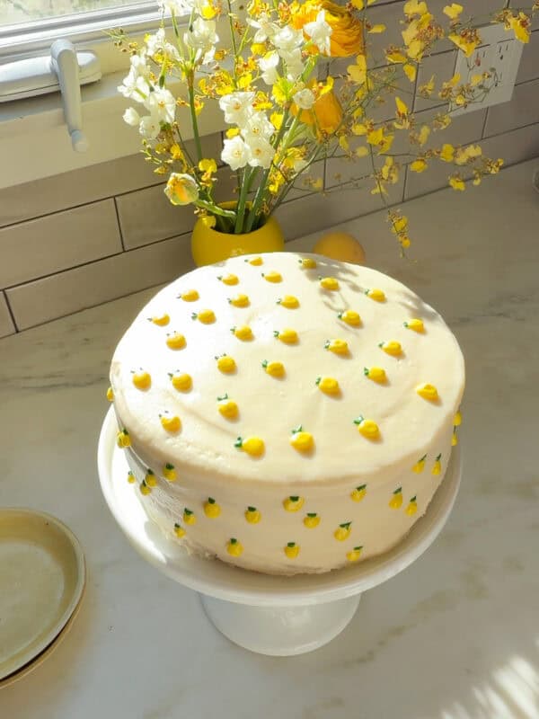 Lemon Cake on a cake stand in the sunlight.