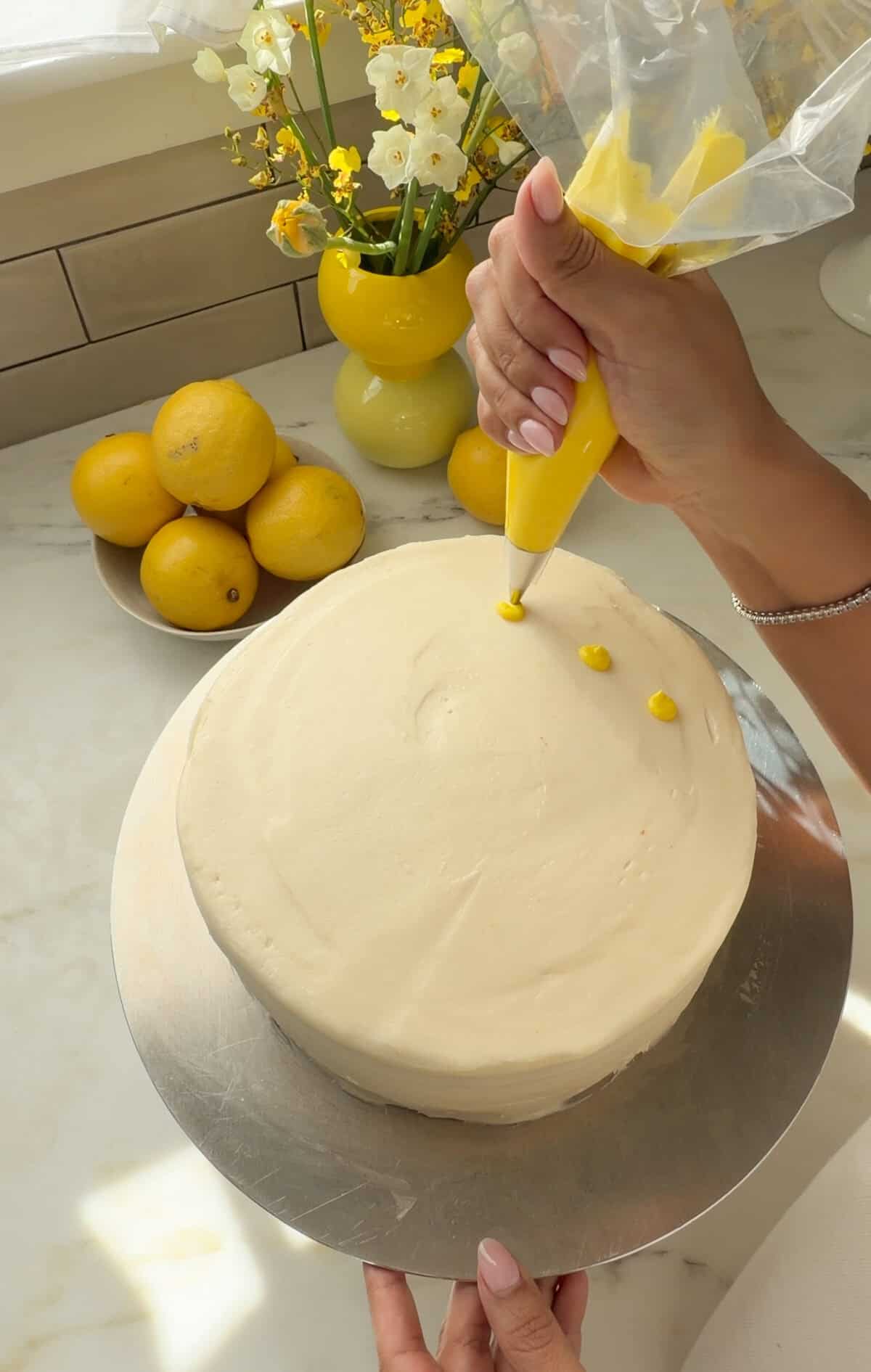Lemons being piped onto cake.