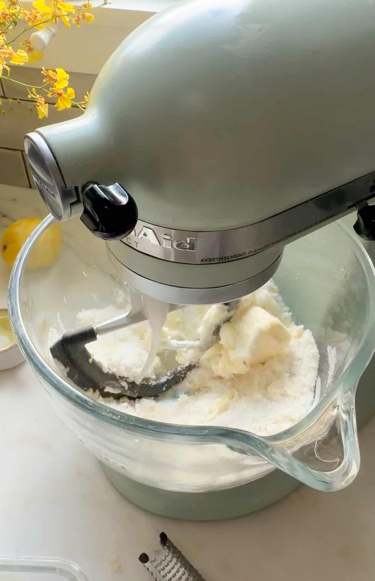 A KitchenAid Stand Up Mixer beating sugar and butter together.