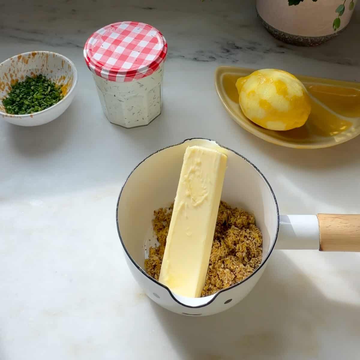 Butter in a small pot with lemon pepper seasoning.
