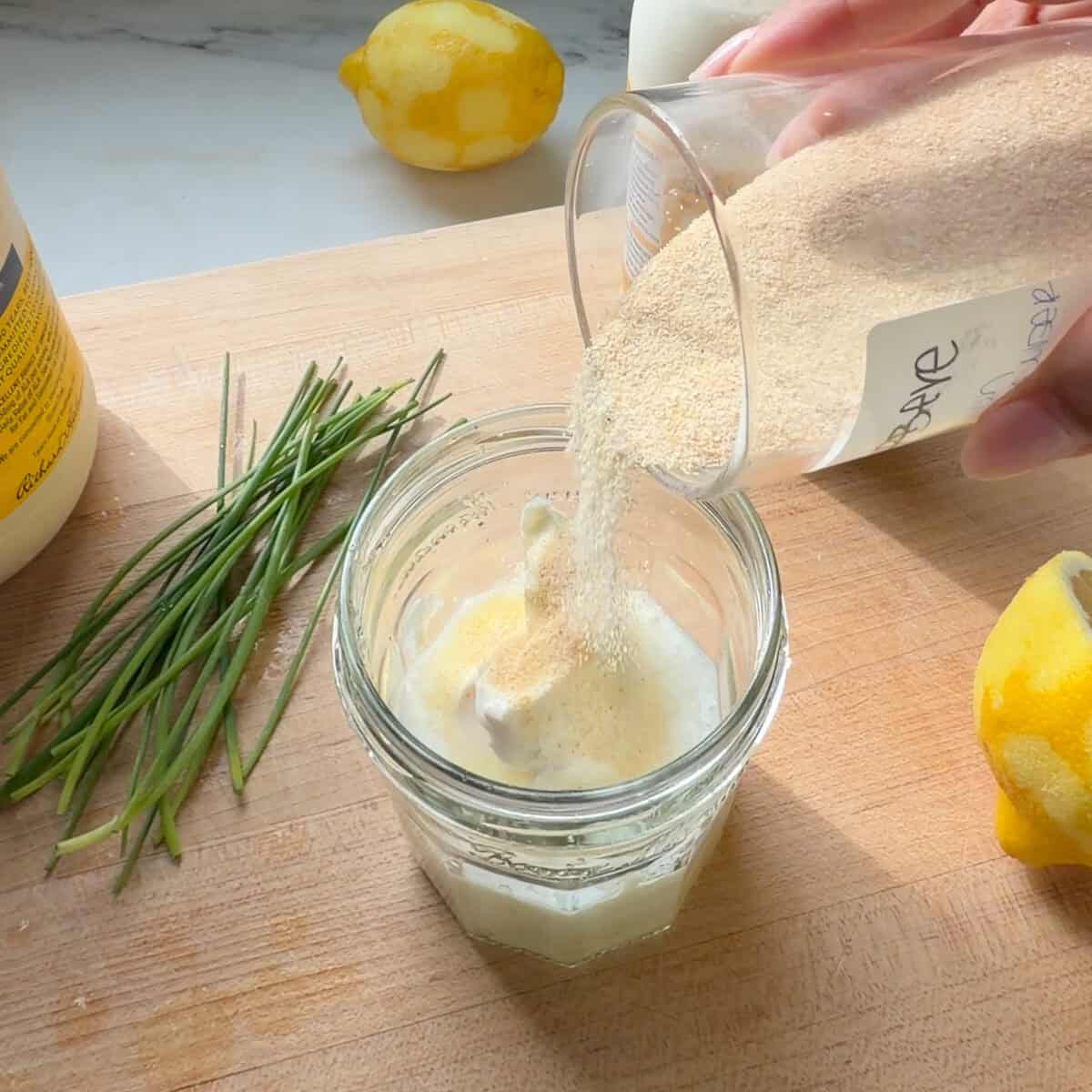 Onion powder poured into buttermilk ranch.