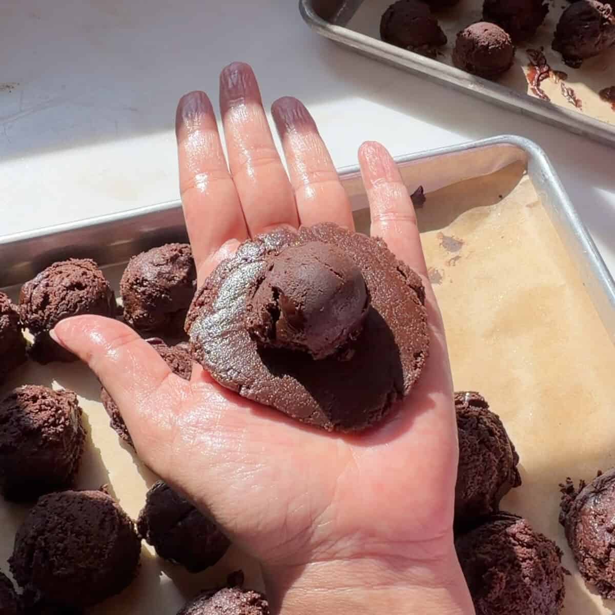 Flattened Brownie Pudding Cookie dough with ganache in center.