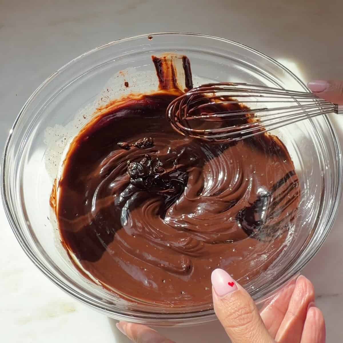 Whisking chocolate ganache.