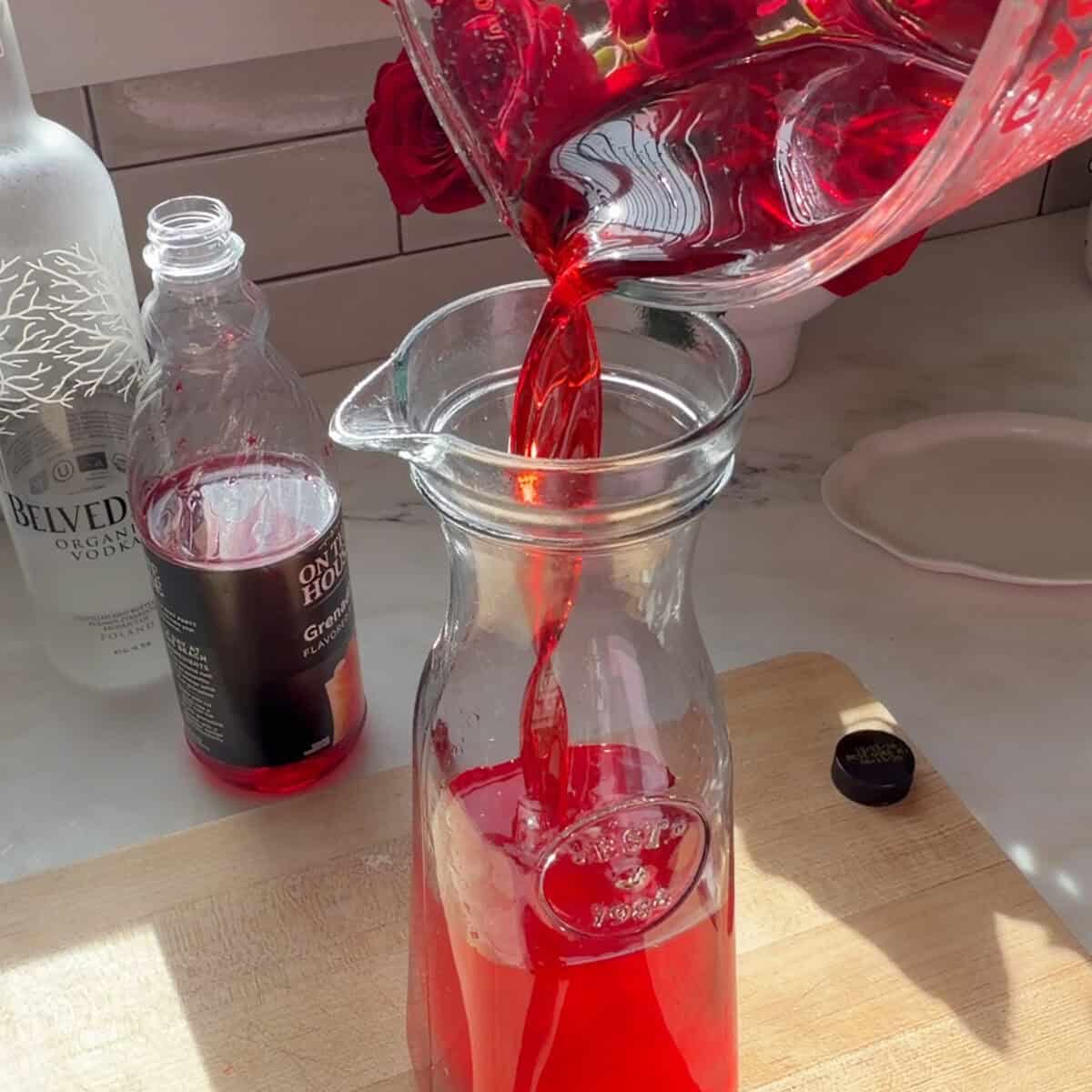 Adding grenadine to vodka.