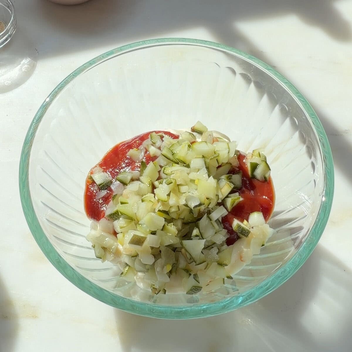 Mayo, ketchup, pickles in small bowl.