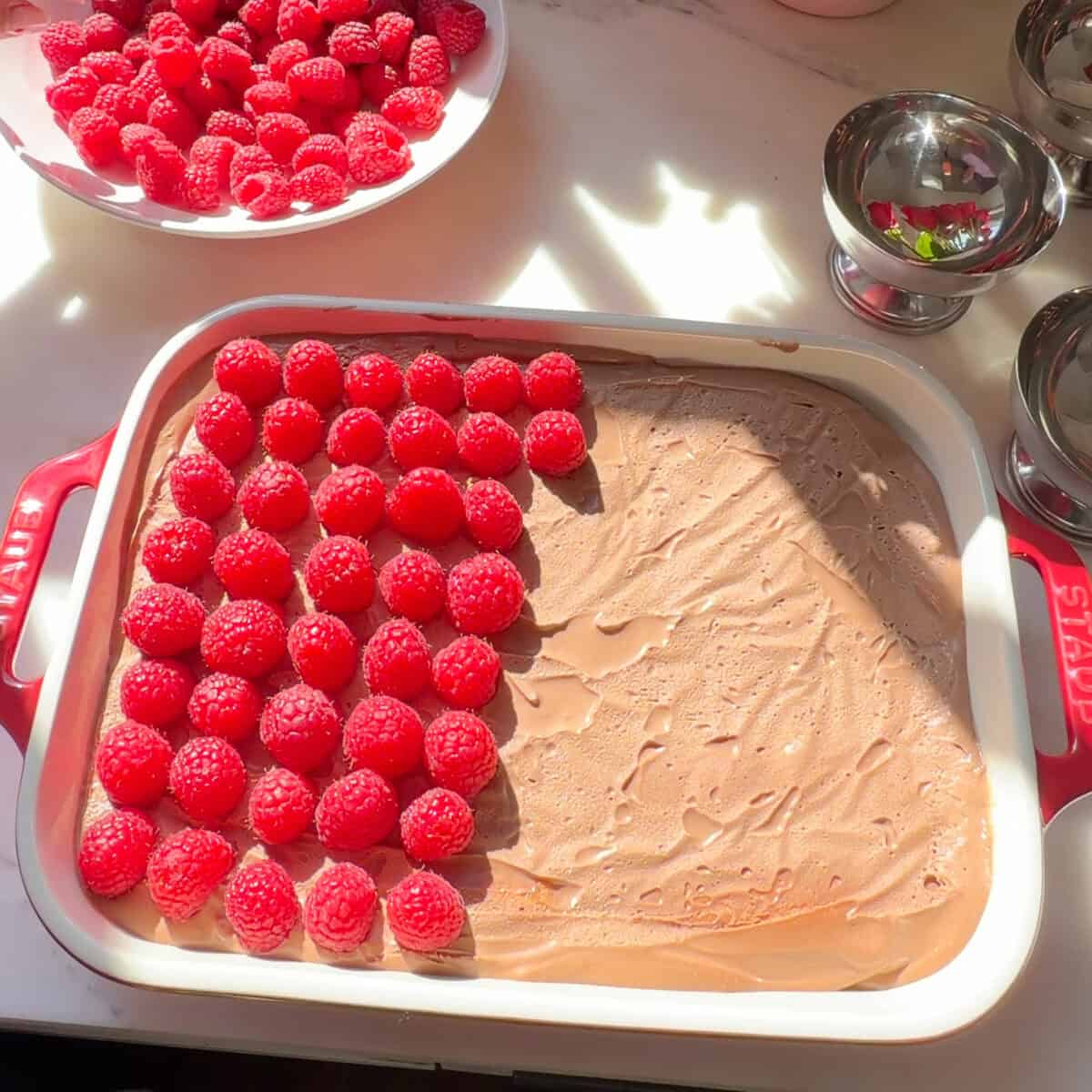 Chocolate Raspberry Tiramisu with raspberries on top.